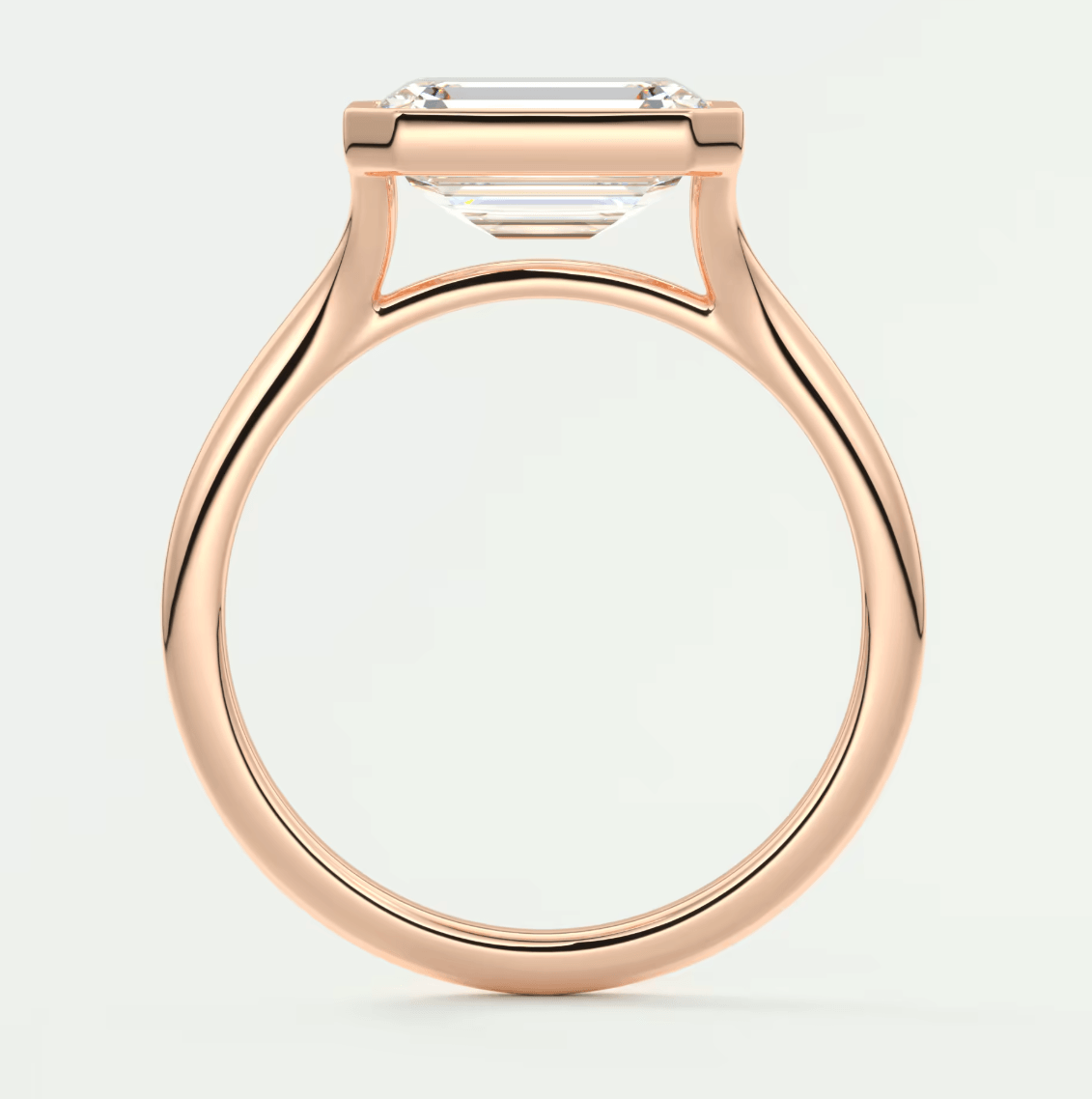 Rose gold engagement ring with emerald cut diamond