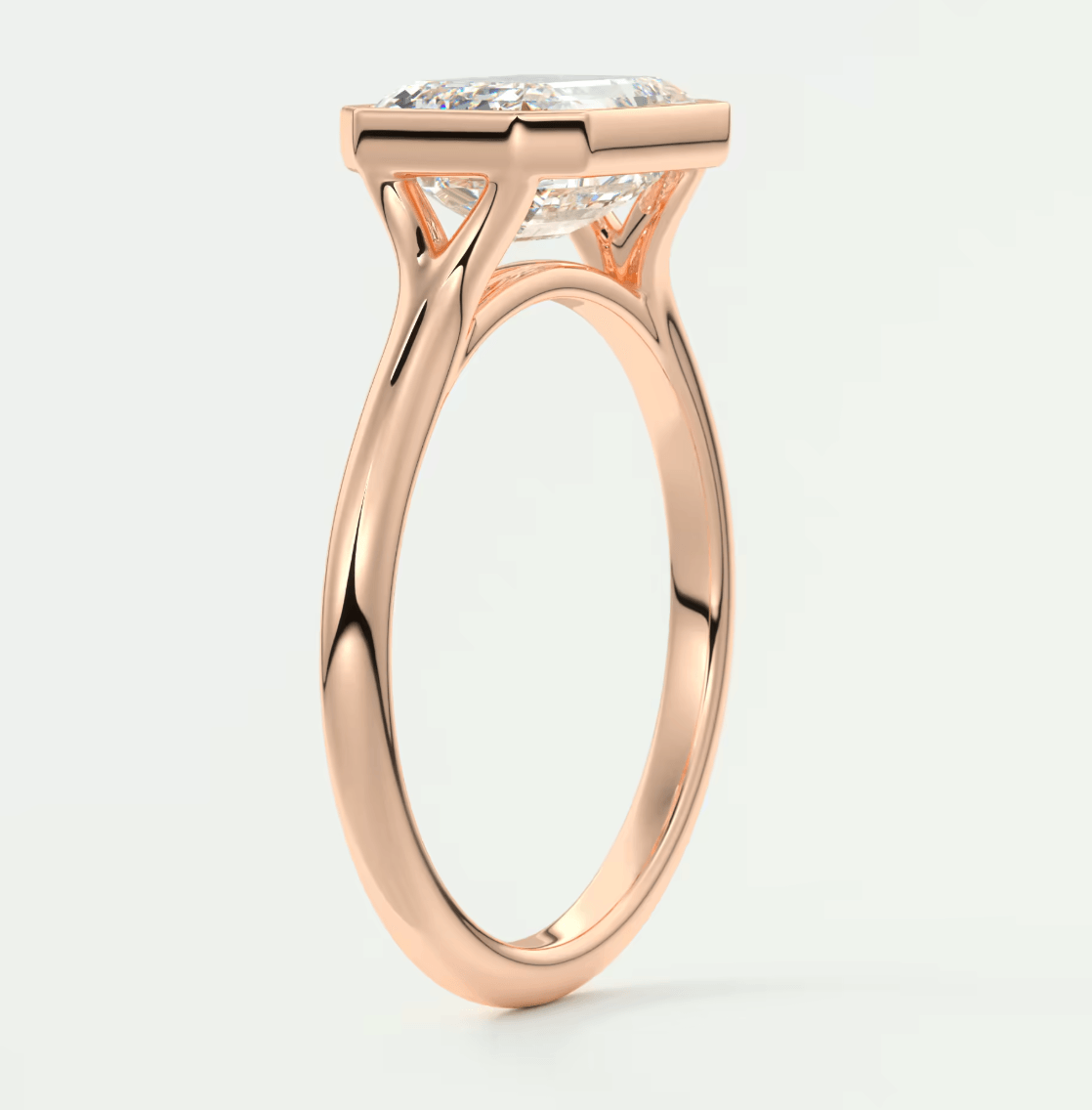 18k rose gold engagement ring with a cushion-cut diamond.