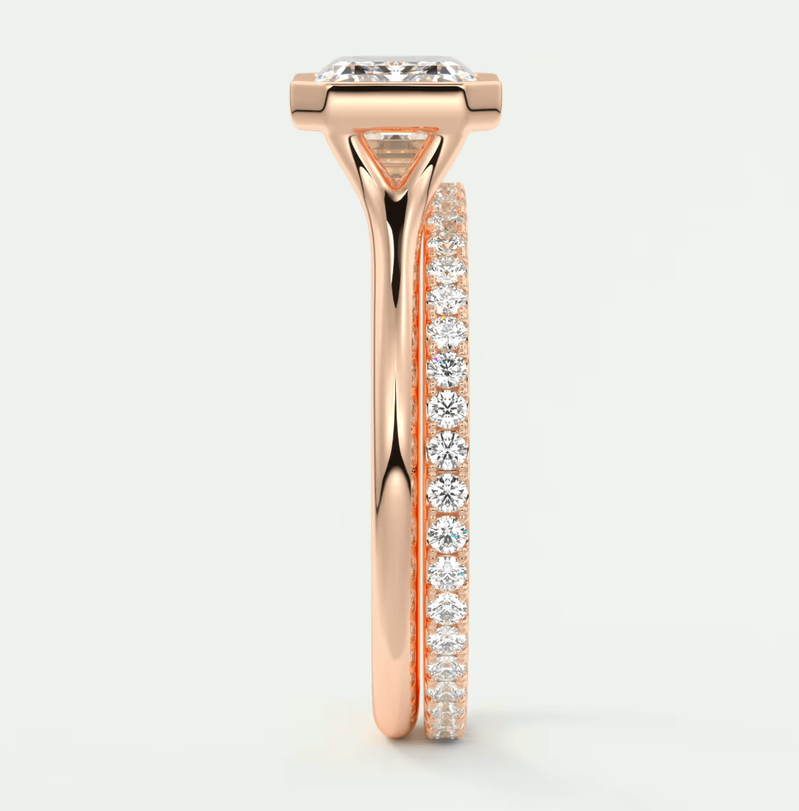 18k rose gold diamond engagement ring with a princess cut center stone and pavé set side stones.