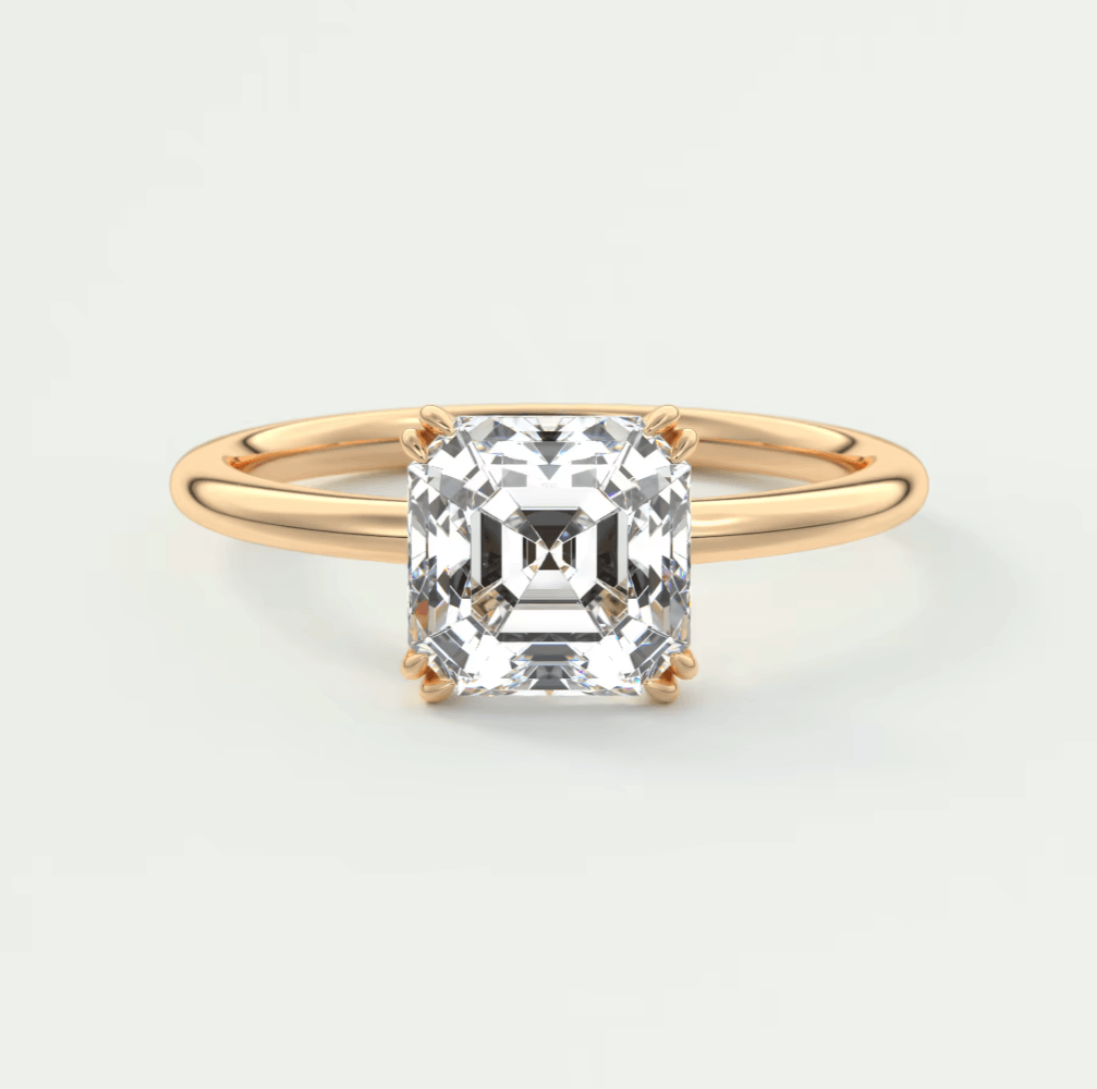 18-karat gold engagement ring with a cushion-cut diamond.