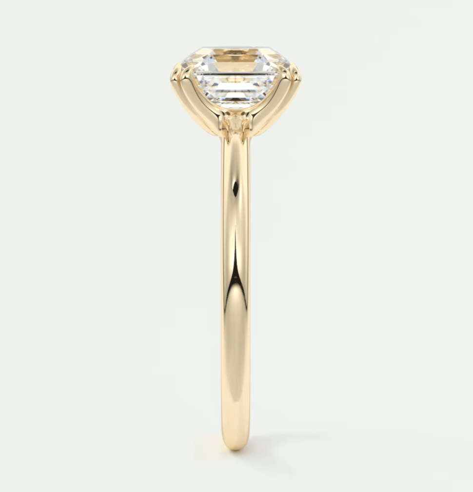 18k yellow gold engagement ring with a marquise-cut diamond.