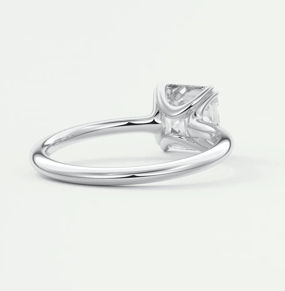 Silver diamond engagement ring with a princess cut gemstone and four prongs.