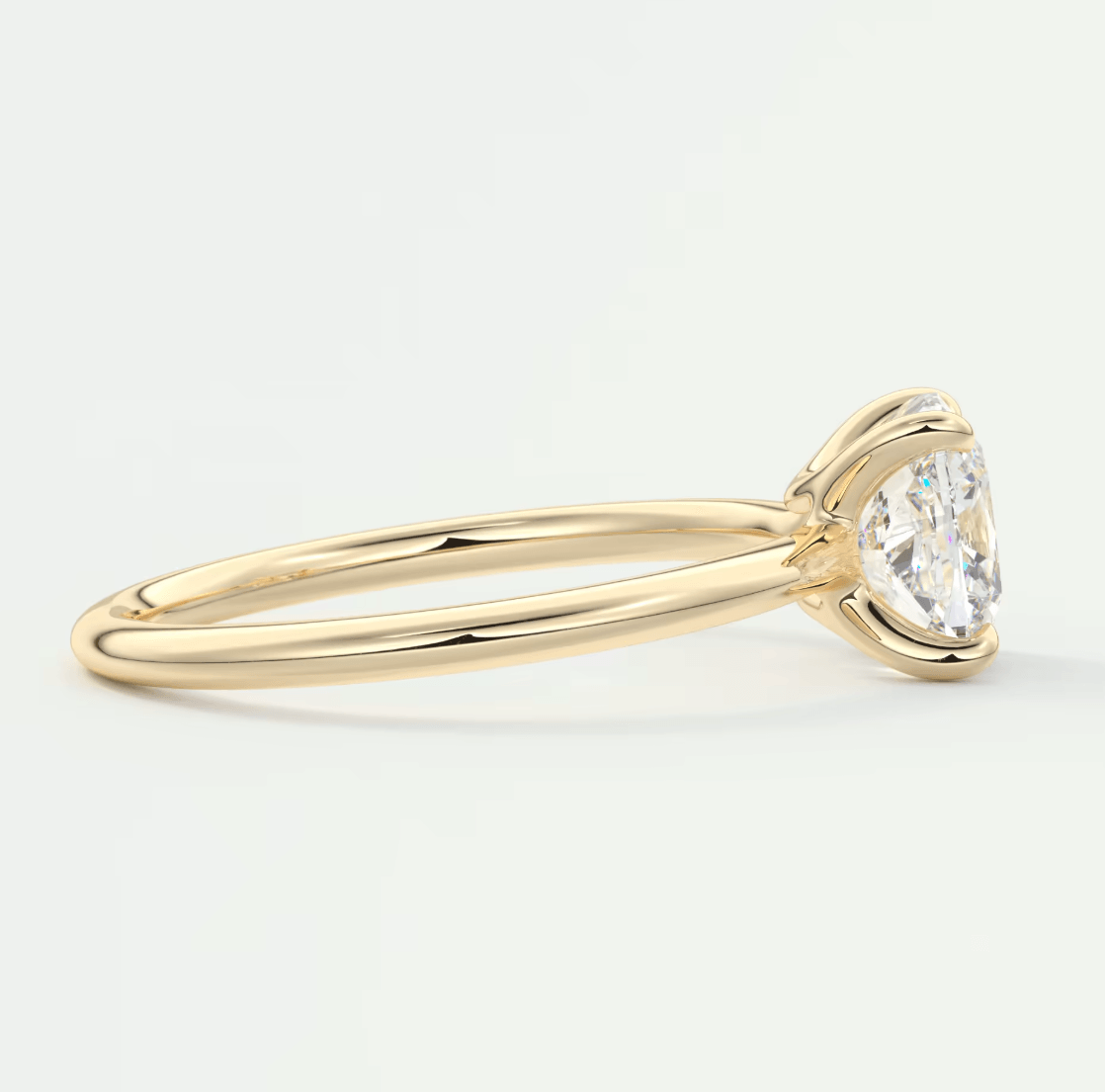 18-karat yellow gold solitaire engagement ring with a round diamond.