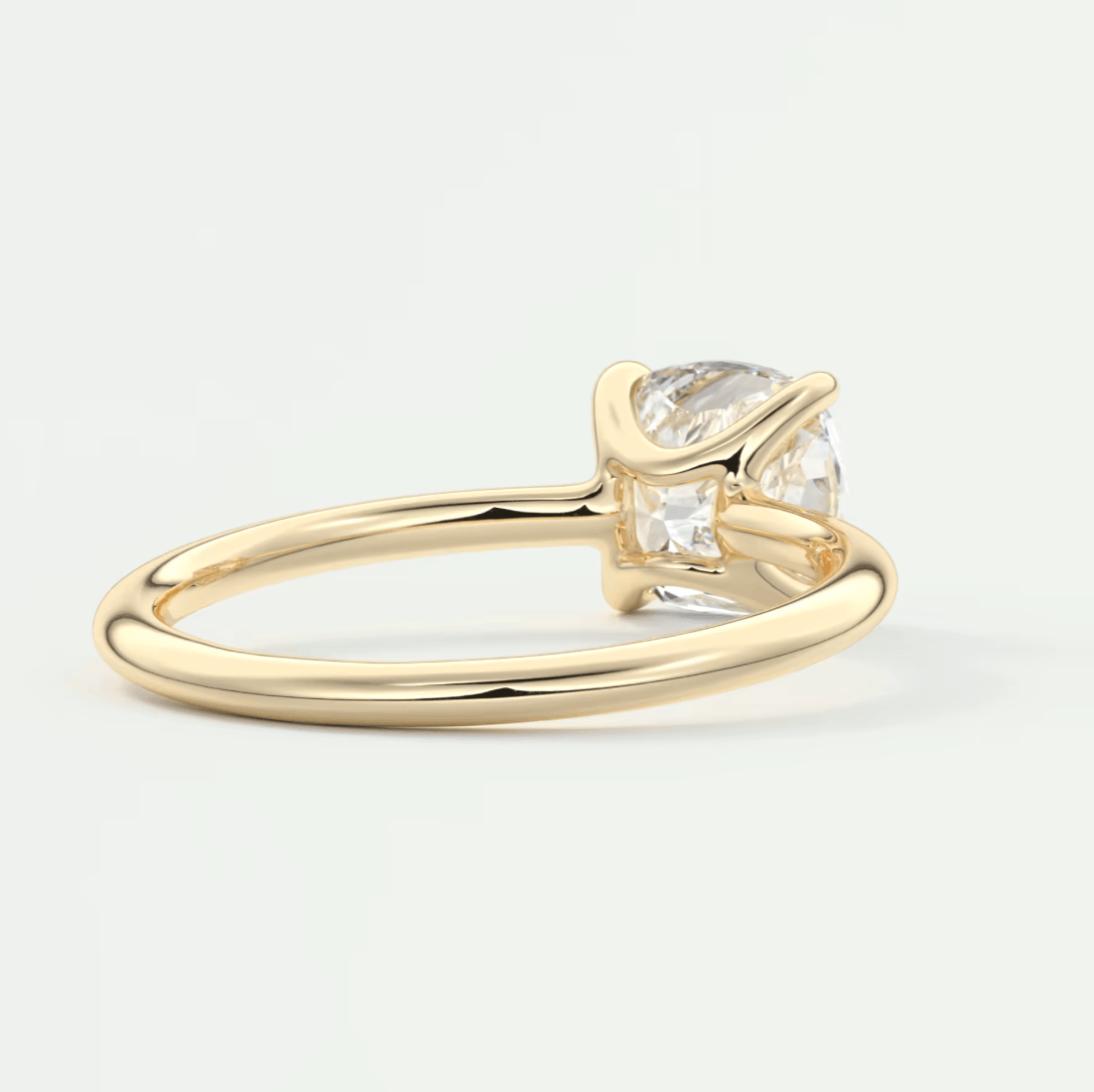 Gold engagement ring with a pear-shaped diamond and smaller accent stones.