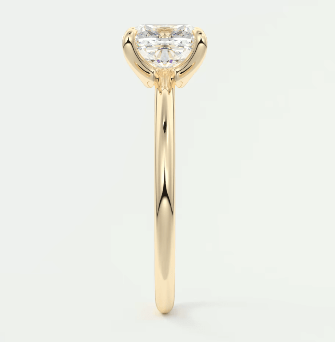 18-karat yellow gold engagement ring with a princess-cut diamond.