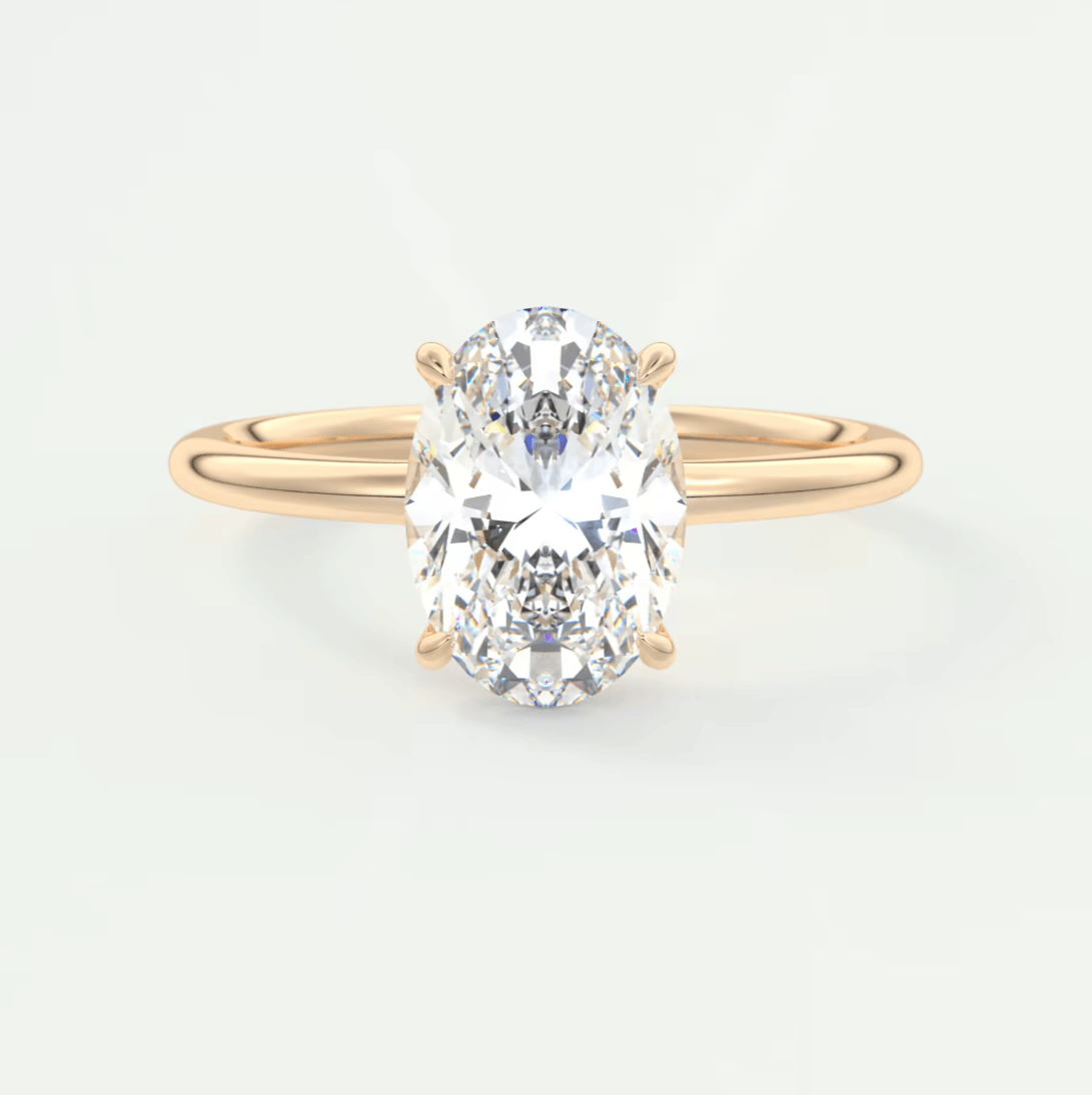 18-karat yellow gold oval diamond engagement ring with a solitaire design.