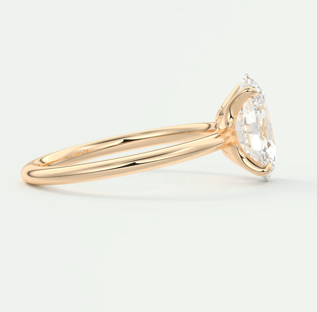 18k gold engagement ring with a marquise-cut diamond.