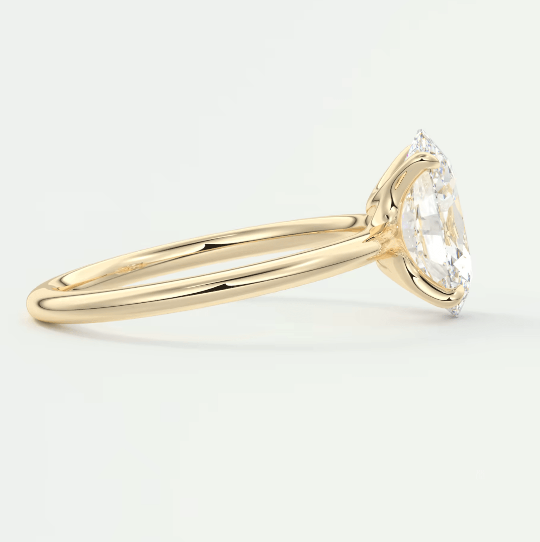 18k yellow gold solitaire engagement ring with a round diamond.