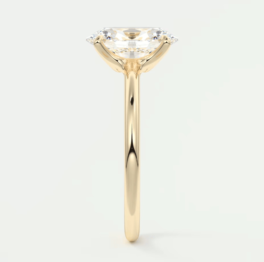 18-karat yellow gold engagement ring with a cushion-cut diamond.
