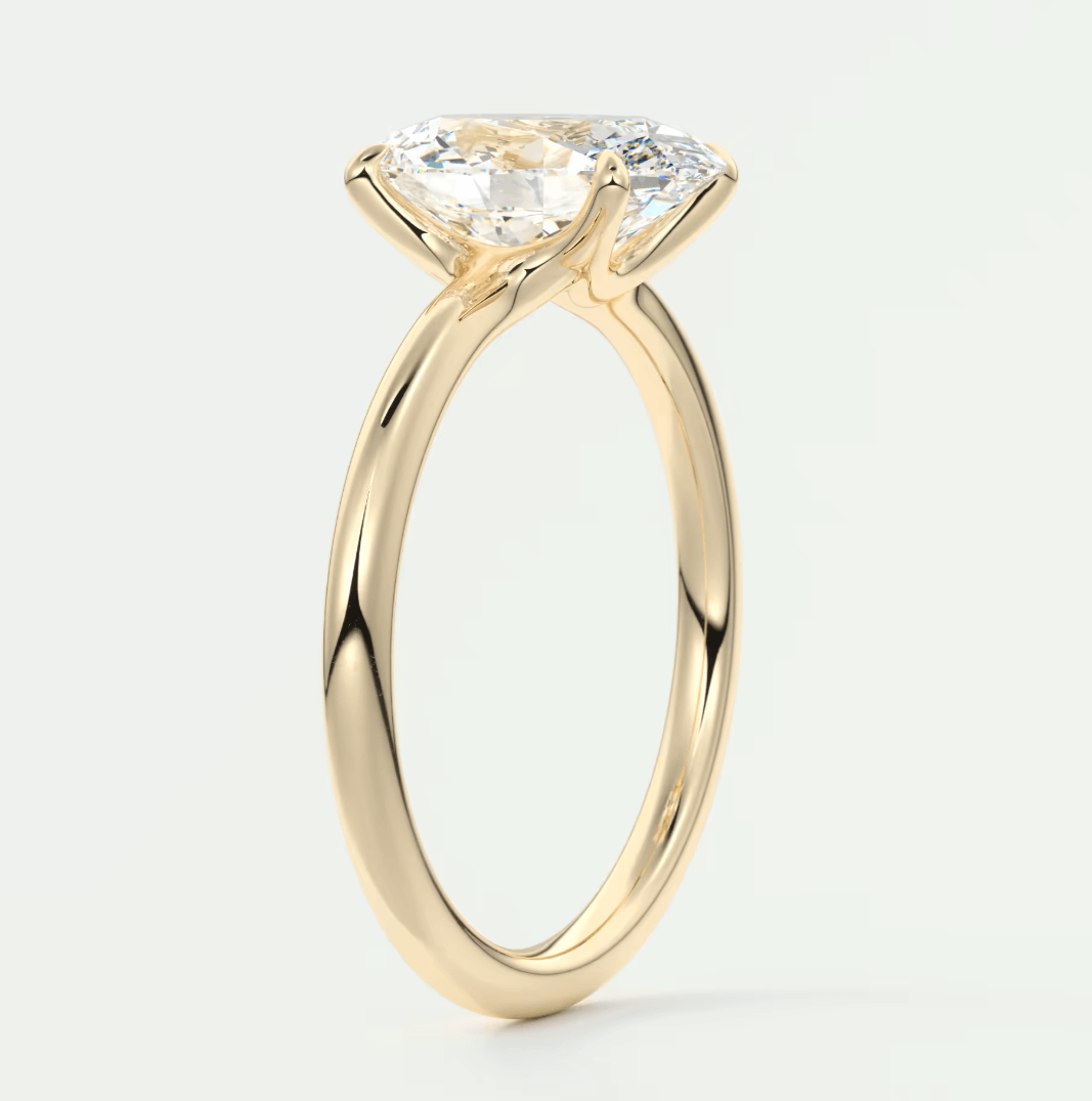 18k yellow gold solitaire engagement ring with a cushion-cut diamond.