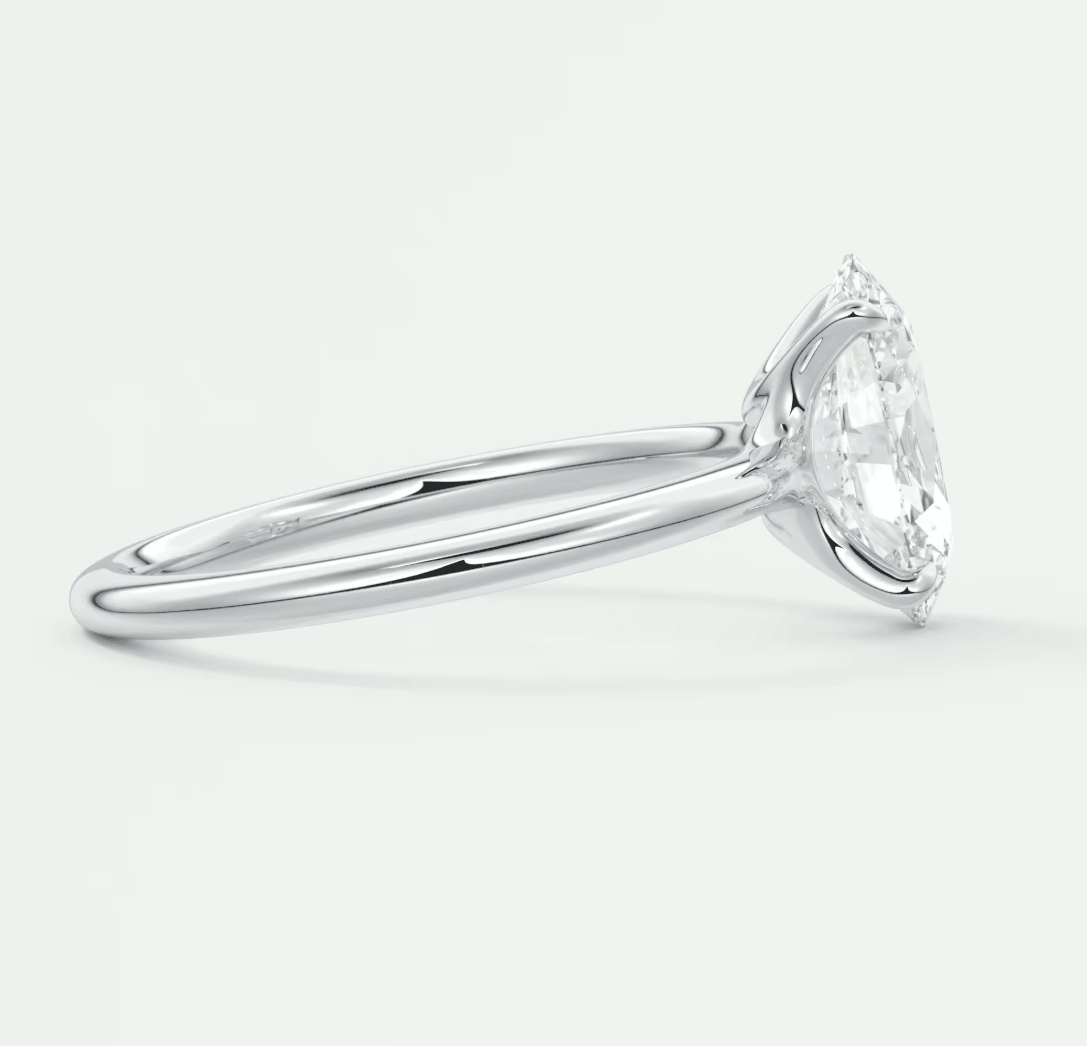 18-karat white gold solitaire engagement ring with a round diamond.