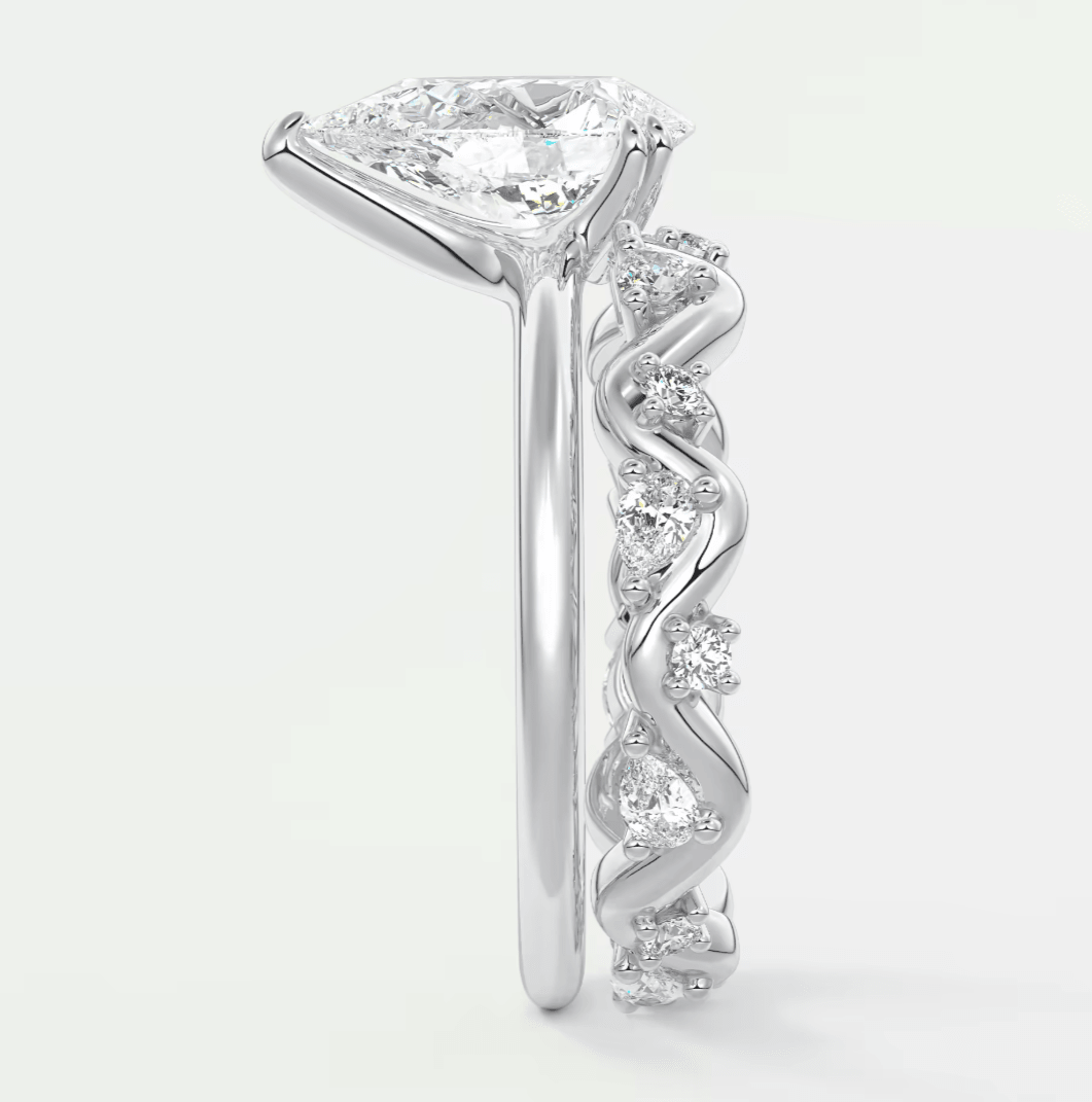 18k white gold diamond engagement ring with a princess cut center stone and twisted band design.