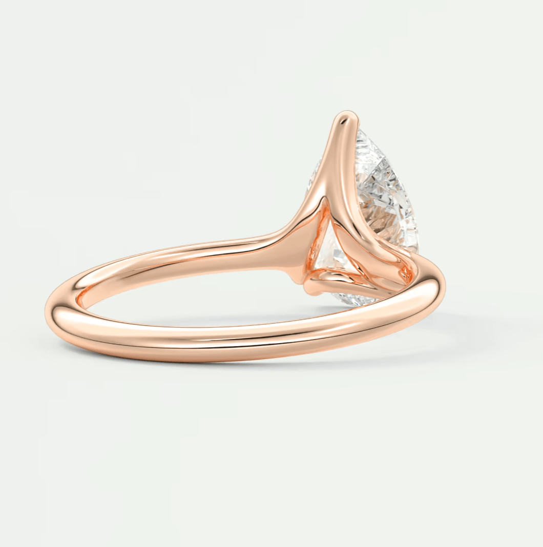 Rose gold diamond engagement ring with a pear-shaped stone.
