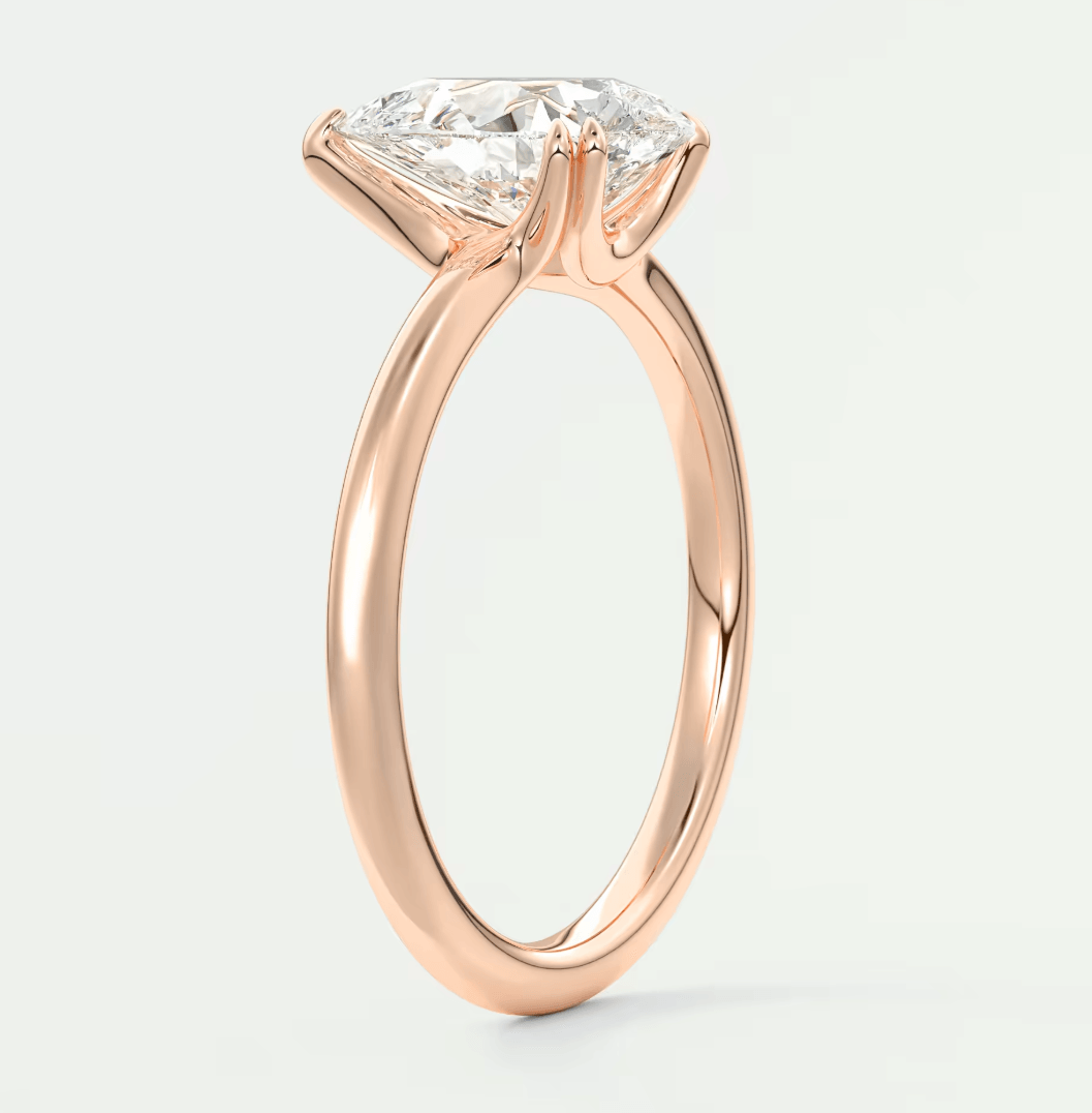 18-karat rose gold engagement ring with a princess-cut diamond.