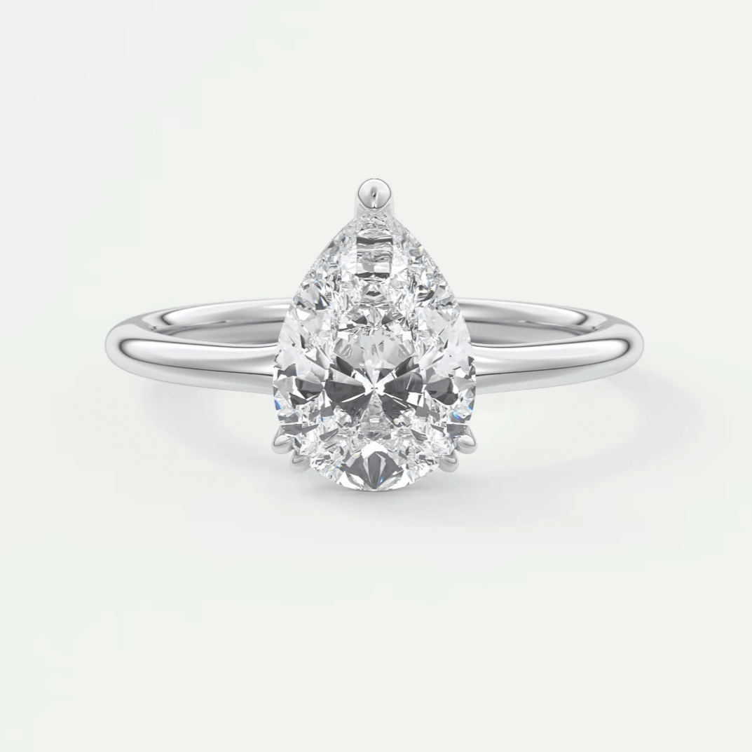 Pear-shaped diamond engagement ring with white gold band and prong setting.