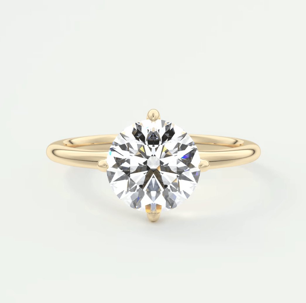 18k yellow gold solitaire diamond engagement ring with a round brilliant cut gemstone.