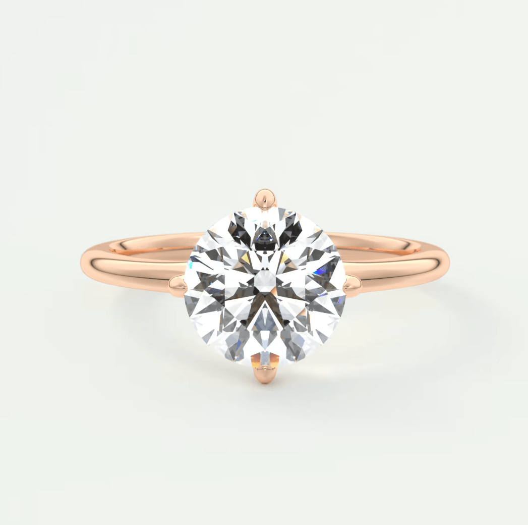 18-karat rose gold solitaire diamond engagement ring.