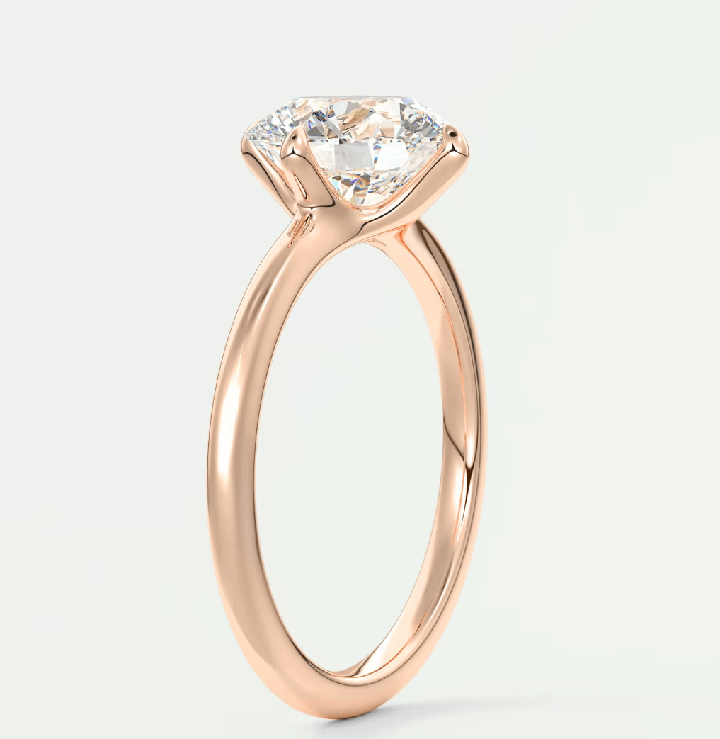 Rose gold diamond engagement ring with a cushion-cut center stone and prong setting.