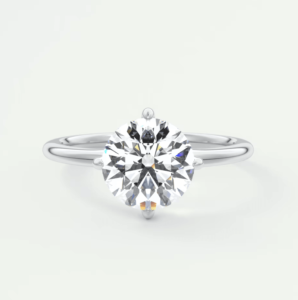 18-karat white gold solitaire diamond engagement ring with a round brilliant cut gem.