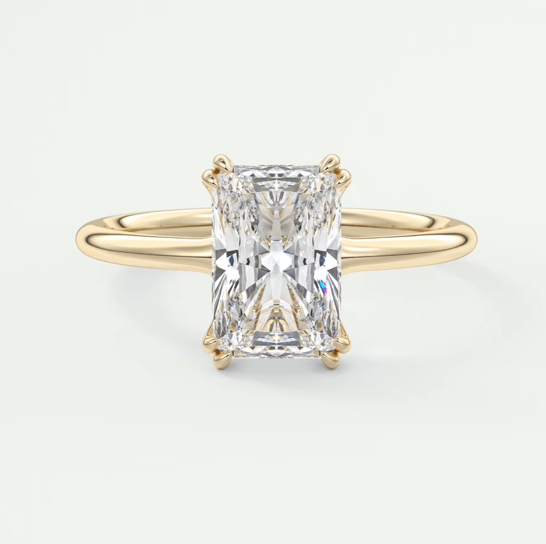18k yellow gold engagement ring with an emerald-cut diamond.