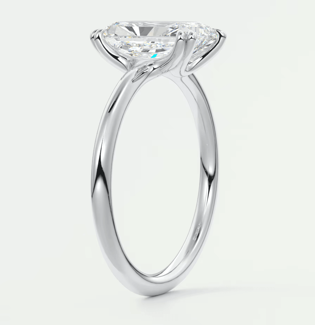18-karat white gold solitaire engagement ring with a cushion-cut diamond.