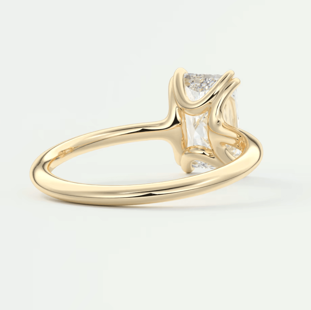 18k yellow gold engagement ring with a baguette diamond and small round diamonds on the band.