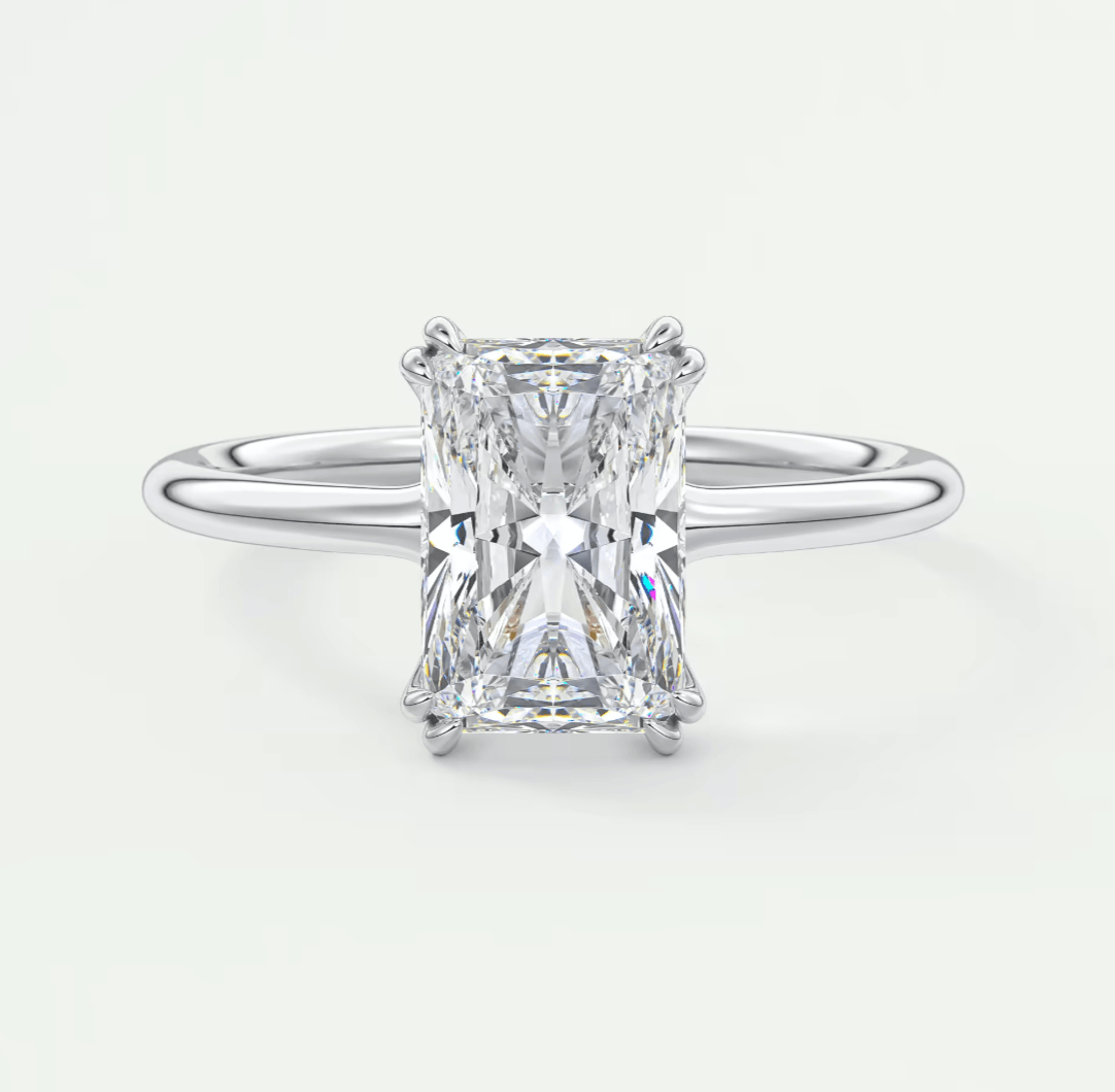 18-karat white gold engagement ring with a radiant cut diamond.
