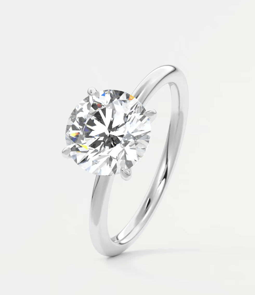 18-karat white gold solitaire diamond engagement ring.