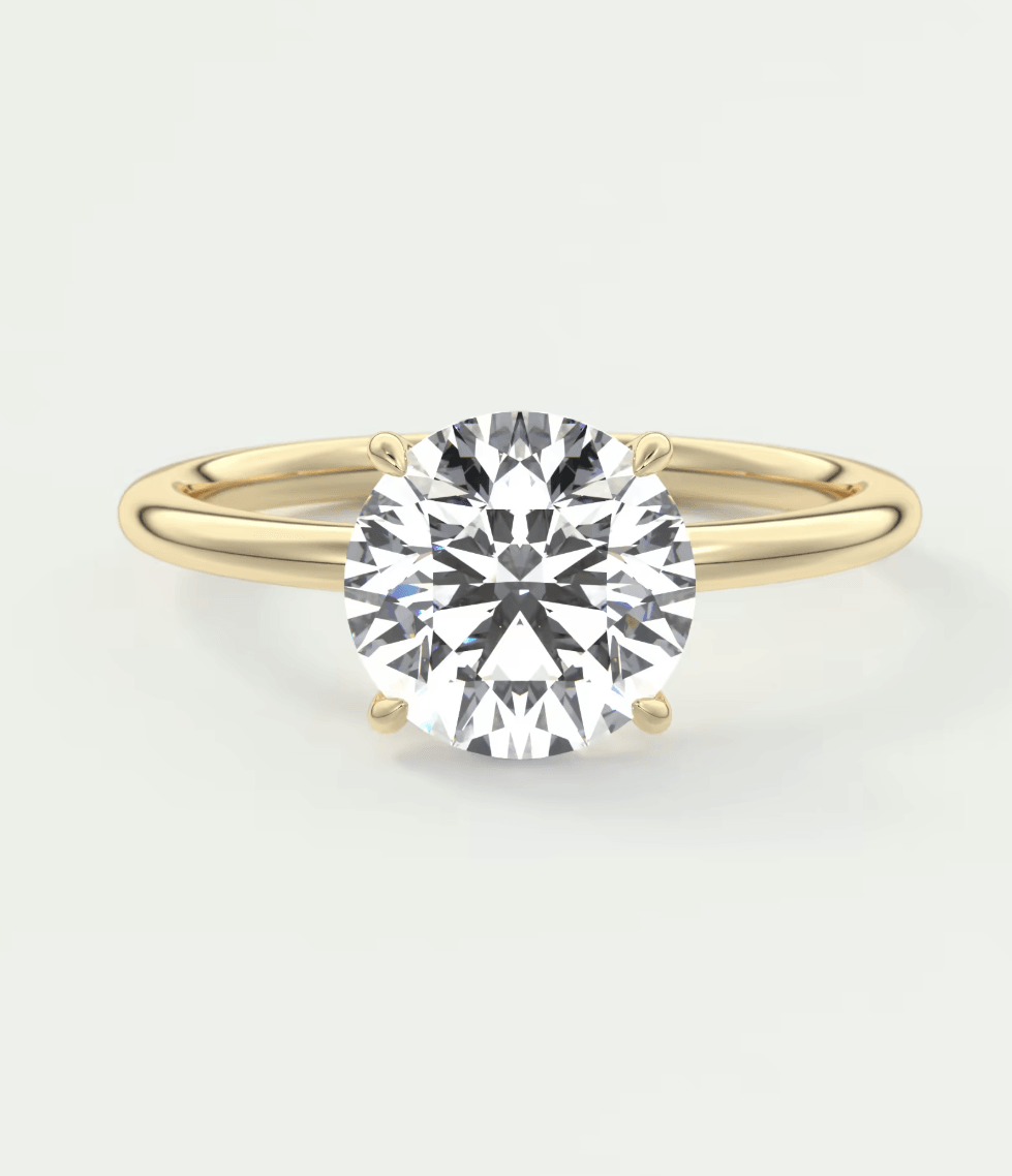 18-karat yellow gold solitaire diamond engagement ring.
