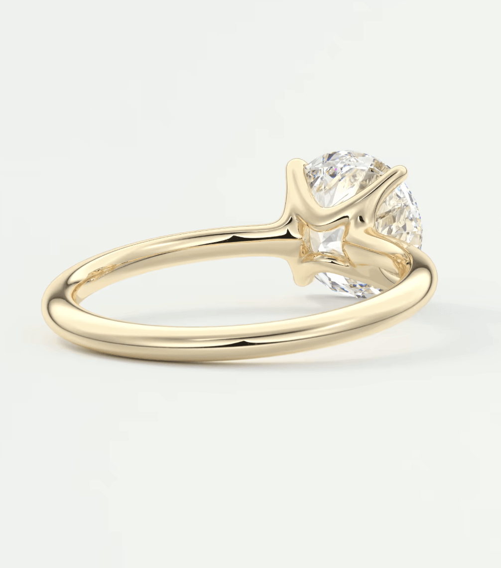 18k yellow gold solitaire diamond engagement ring with a round brilliant cut gemstone.