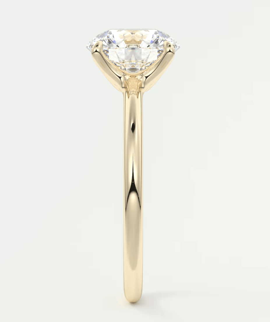 18-karat yellow gold solitaire engagement ring with a round diamond.