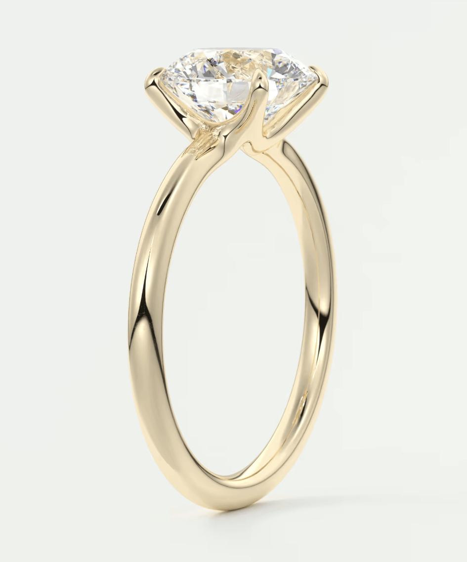 18k yellow gold solitaire diamond engagement ring with a twisted band design.