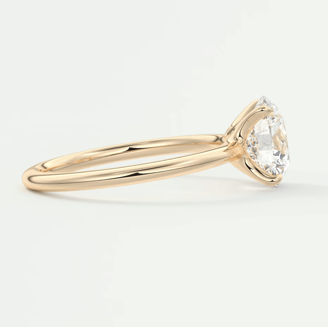 18-karat gold engagement ring with a pear-shaped diamond.