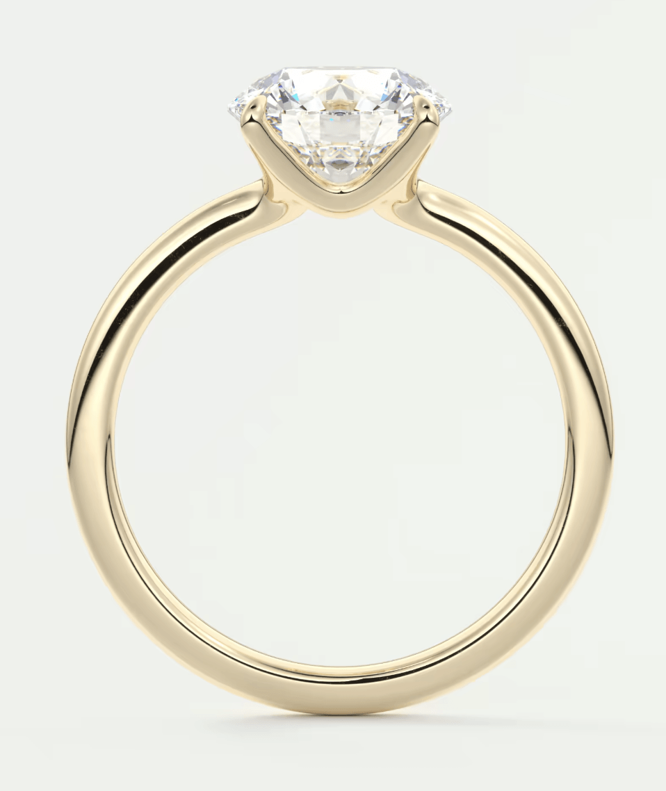 18k yellow gold solitaire diamond engagement ring with a round brilliant cut stone.