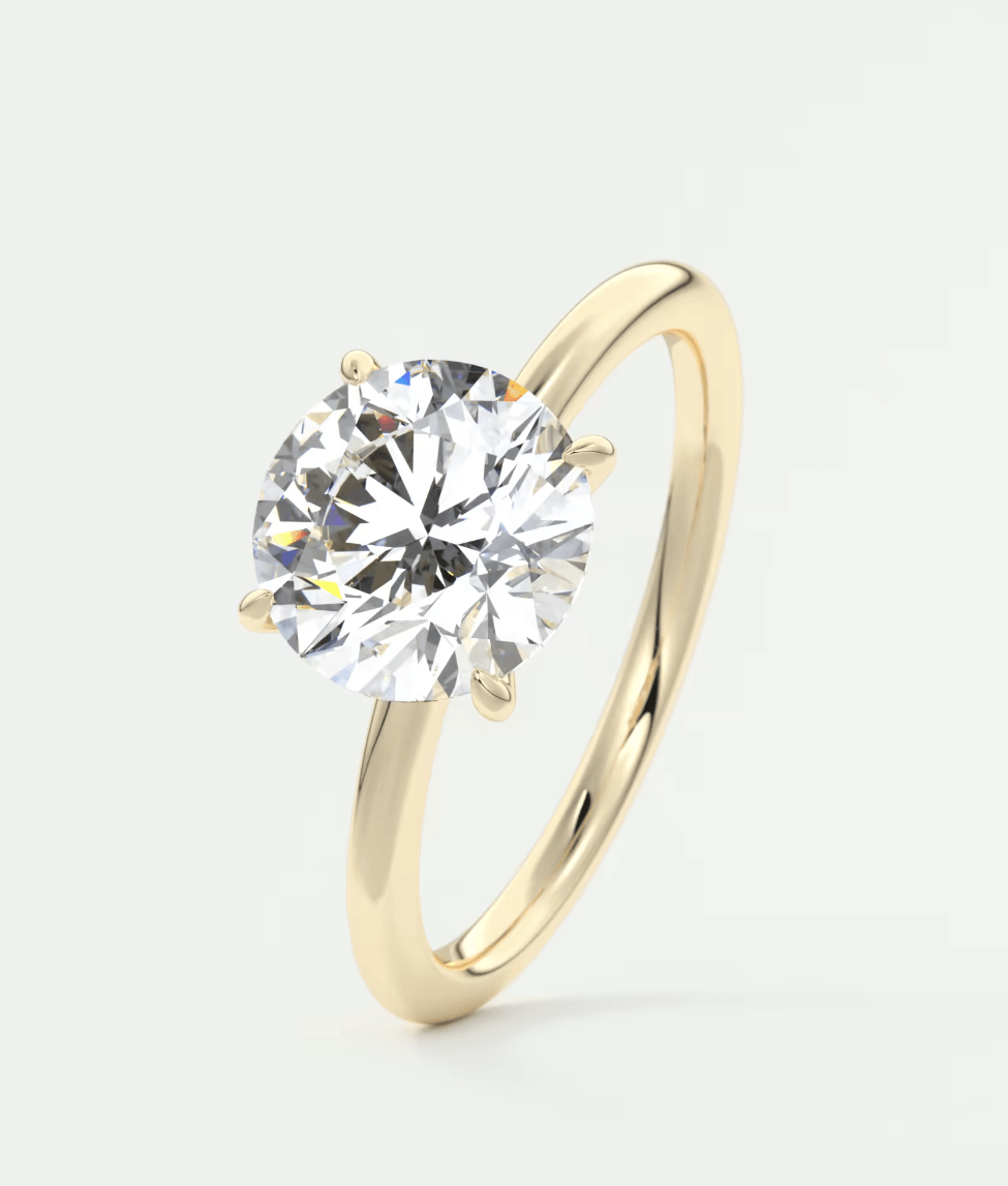 18-karat yellow gold solitaire diamond engagement ring.