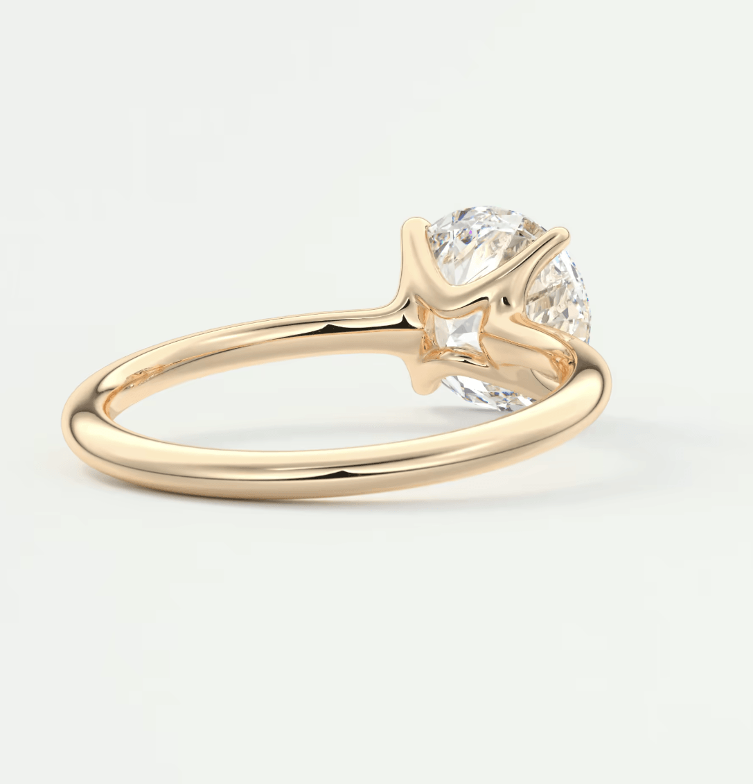 18-karat gold engagement ring with a round diamond.