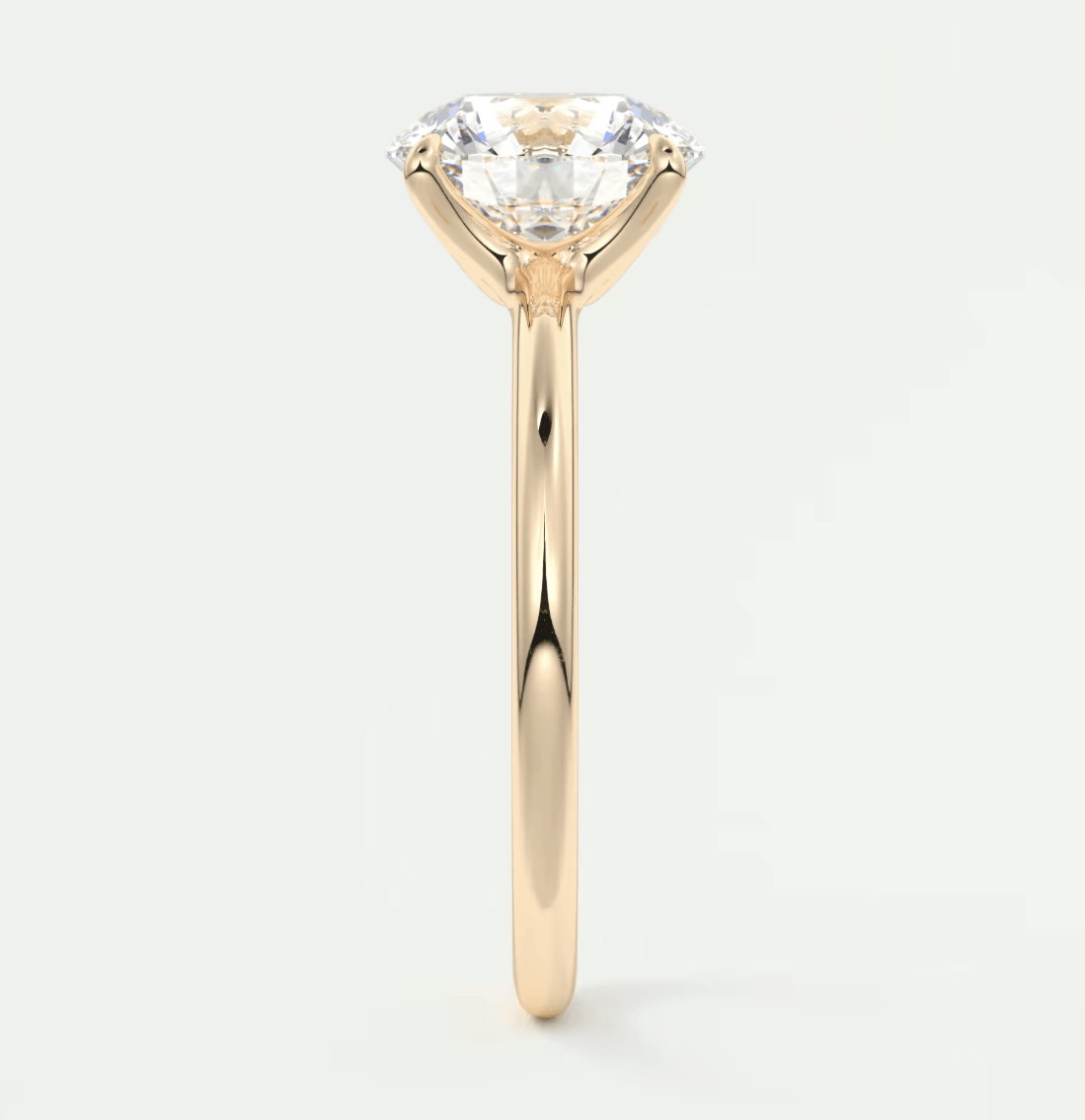 18k gold solitaire diamond engagement ring with a round brilliant cut gem.