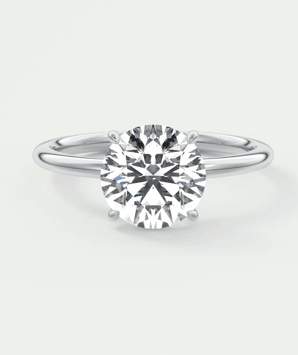 18-karat white gold solitaire diamond engagement ring with a round brilliant cut.