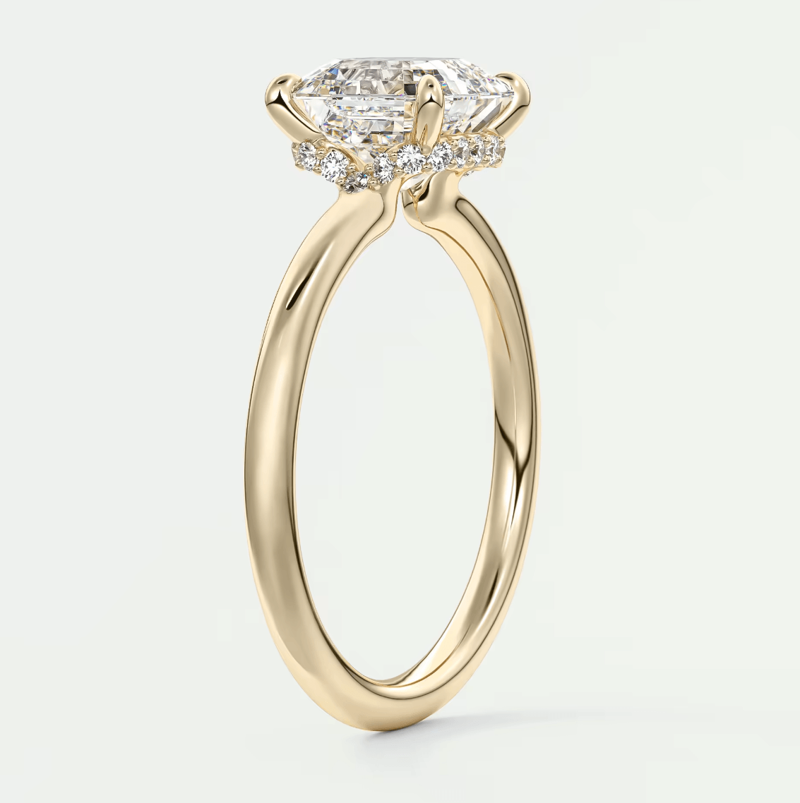 18k yellow gold engagement ring with a marquise-cut diamond and small round diamonds on the band.