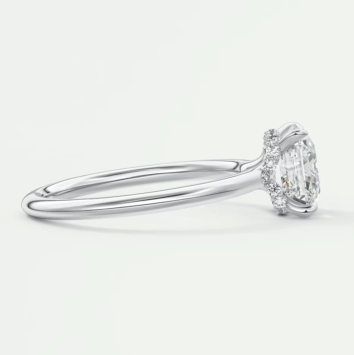 18k white gold diamond engagement ring with a round-cut center stone and halo of smaller diamonds.