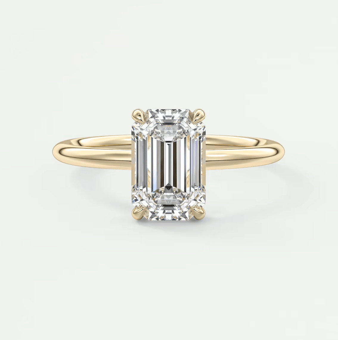 18k yellow gold emerald-cut diamond engagement ring.