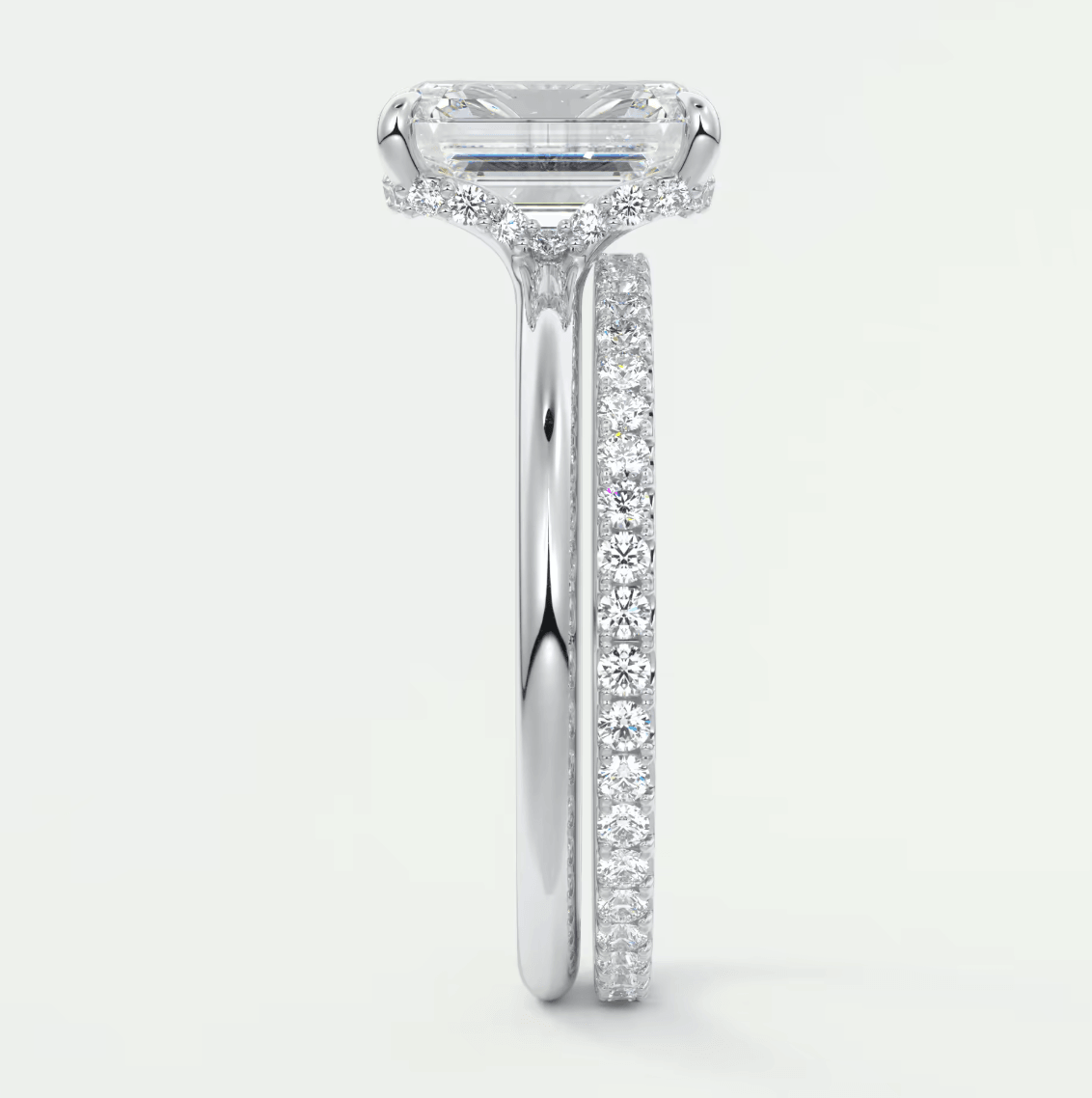 18k white gold emerald cut diamond engagement ring with a halo of diamonds.