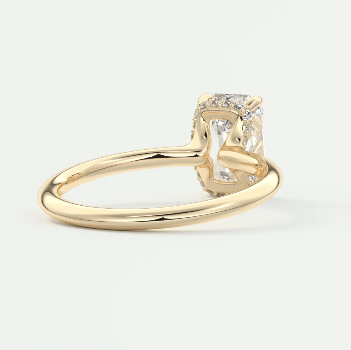 18k yellow gold engagement ring with a cushion-cut diamond and small round diamonds set in the band.