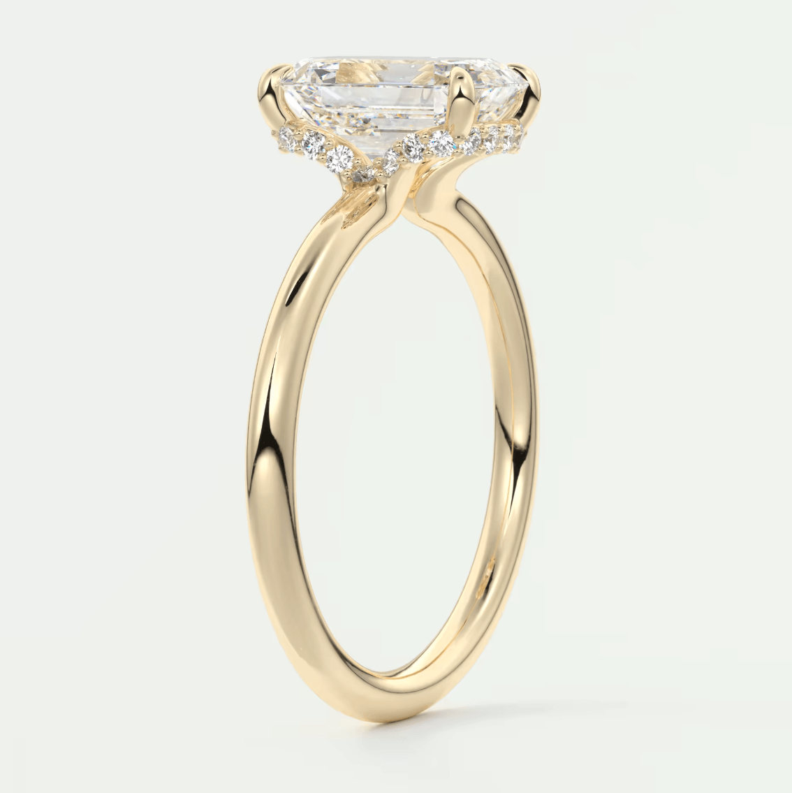 18k yellow gold engagement ring with a princess cut diamond and halo of smaller diamonds.