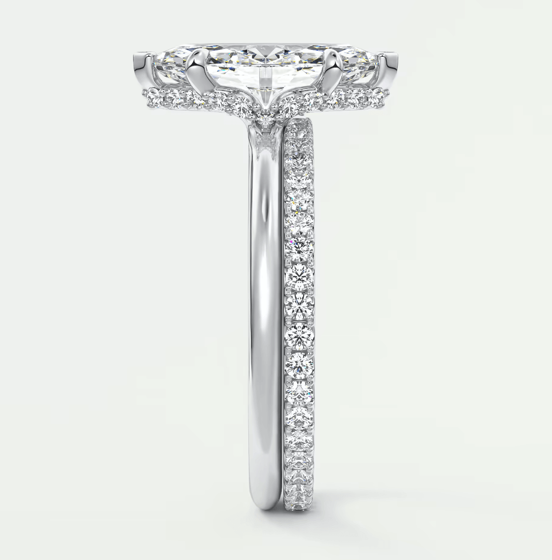 18-karat white gold diamond engagement ring with a cushion-cut center stone and pavé set diamonds on the band.