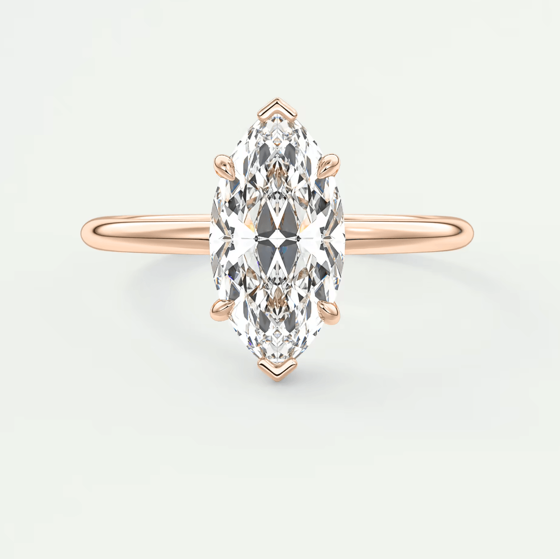 Rose gold marquise diamond engagement ring with intricate detailing and a classic design.