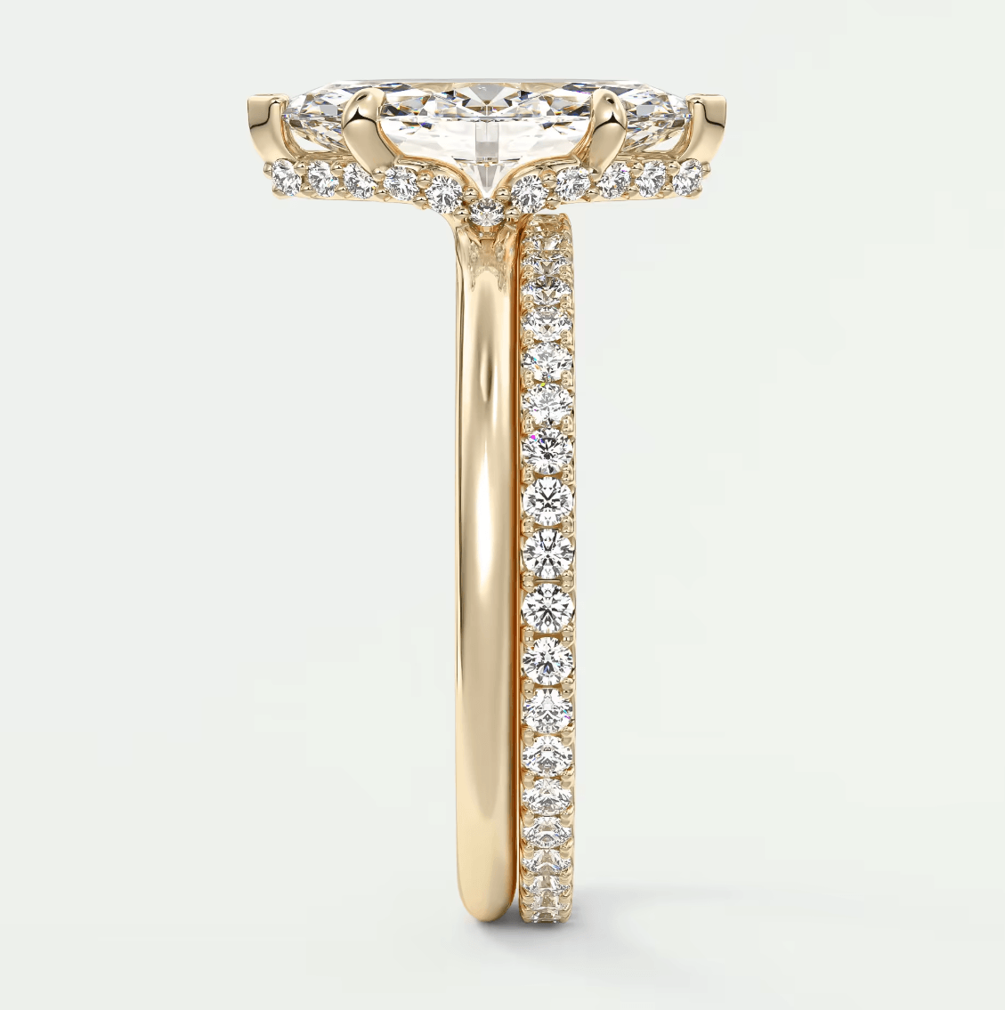 18k yellow gold engagement ring with a round diamond center and pave set diamonds on the band.