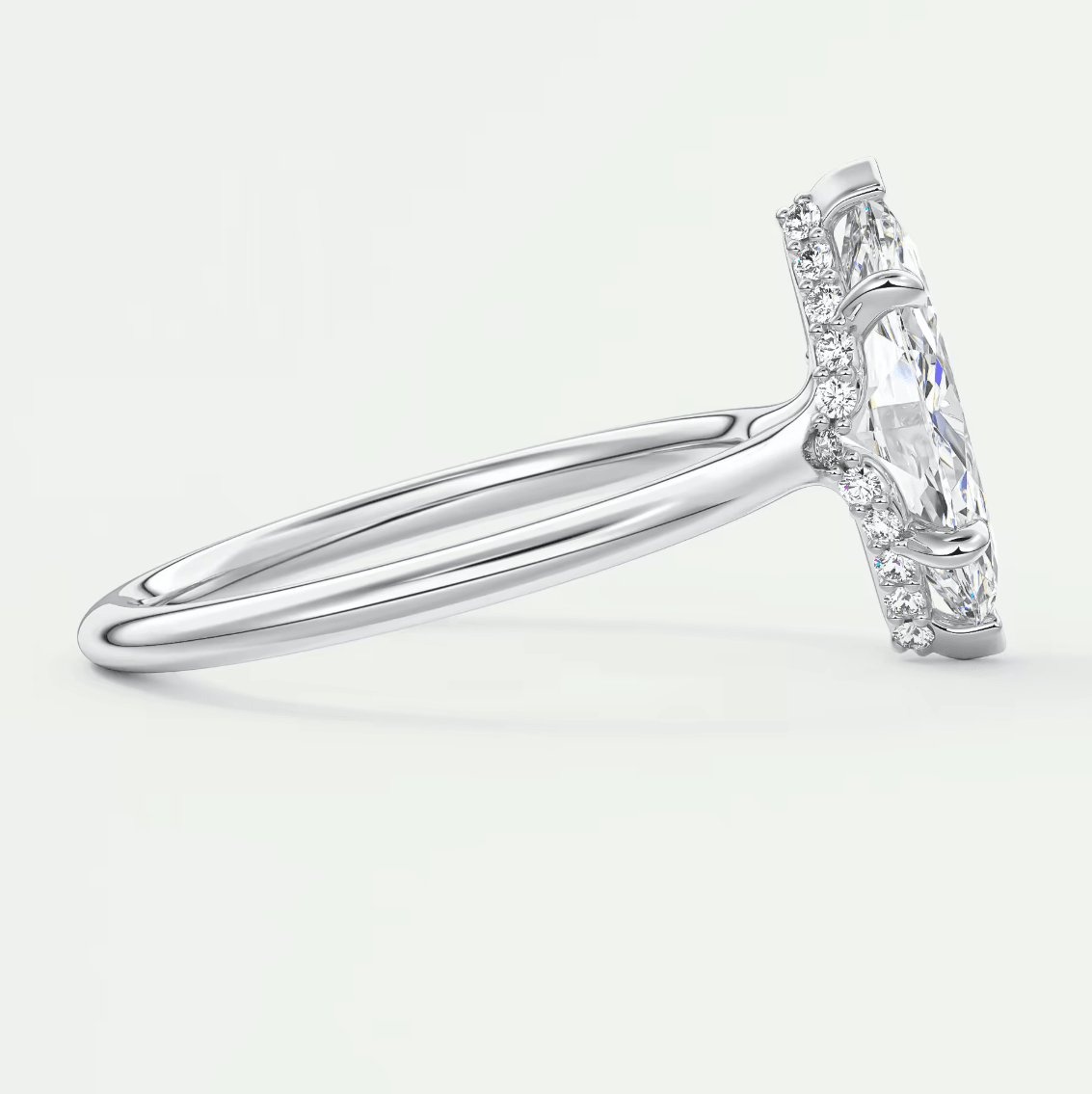 18k white gold engagement ring with a marquise-cut diamond and halo design.