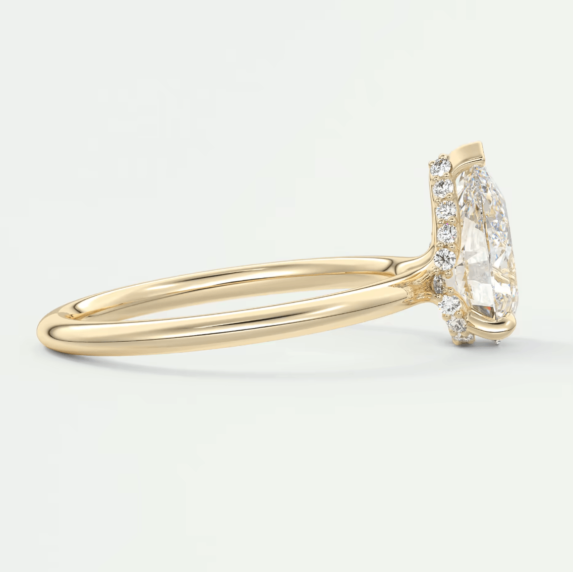 18k yellow gold diamond engagement ring with a marquise-cut center stone and halo of smaller diamonds.
