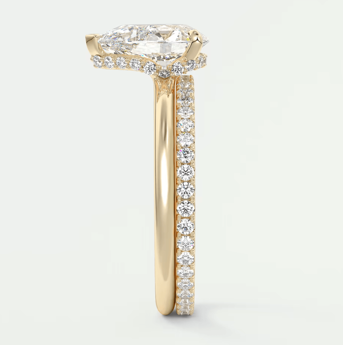 18k yellow gold engagement ring with a cushion-cut diamond center stone and pavé diamonds on the band.